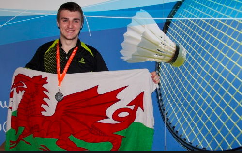 Jack Wilson holding welsh flag with medal round his neck